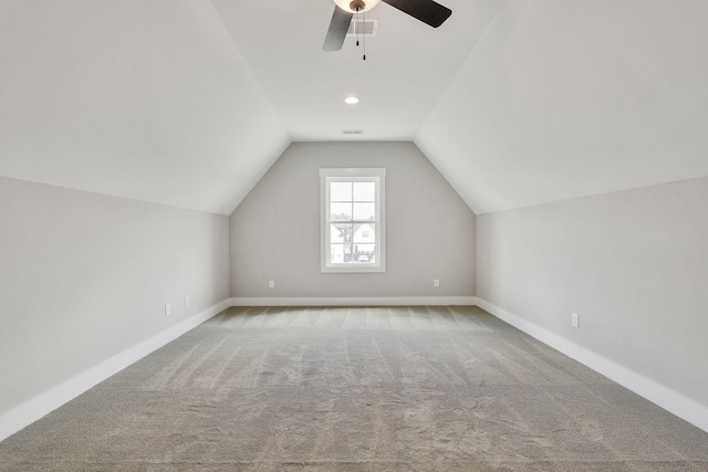 additional living space with lofted ceiling, carpet, visible vents, and baseboards