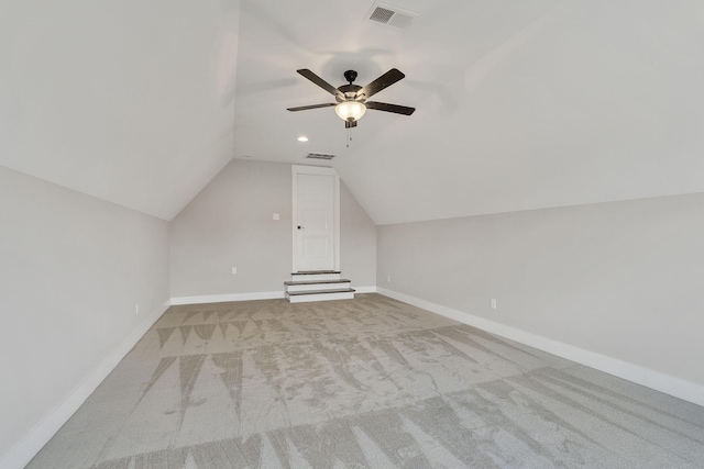 additional living space with carpet floors, visible vents, vaulted ceiling, and baseboards