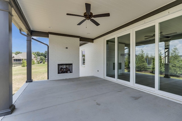 view of patio featuring ceiling fan and an outdoor brick fireplace