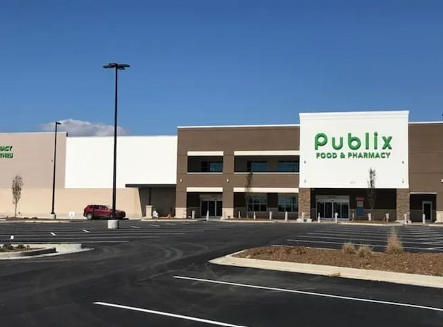 view of building exterior featuring uncovered parking