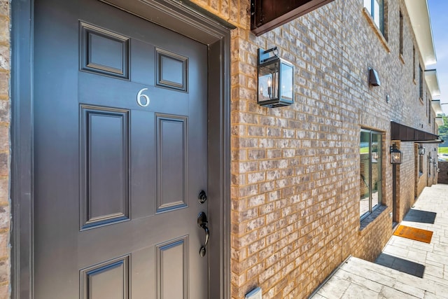 property entrance with brick siding