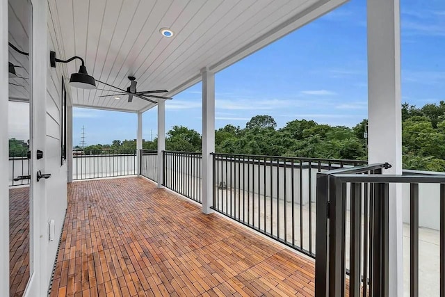 view of patio with a ceiling fan and a balcony