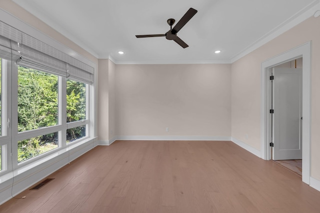 empty room with light wood finished floors, baseboards, visible vents, ornamental molding, and recessed lighting