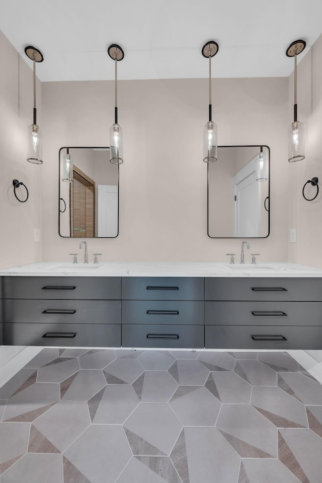 bathroom with double vanity, a sink, and tile patterned floors