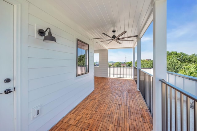 view of patio / terrace with a balcony and a ceiling fan