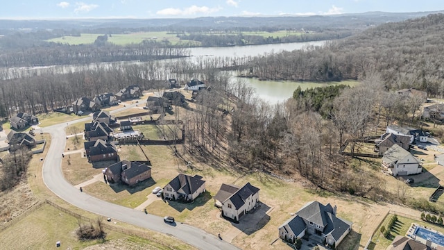 aerial view featuring a forest view and a water view