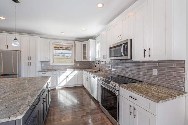 64 Harbor Pt, Lebanon, TN 37087 - kitchen featuring stainless steel appliances, a sink, light stone counters, white cabinetry, and decorative light fixtures