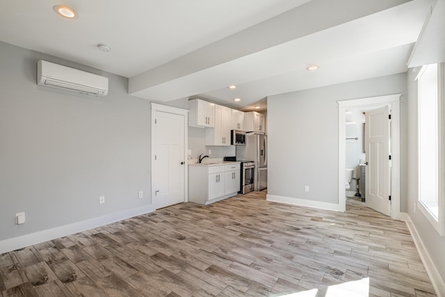 64 Harbor Pt, Lebanon, TN 37087 - unfurnished living room with a wall mounted AC, a sink, light wood-style flooring, baseboards, and recessed lighting