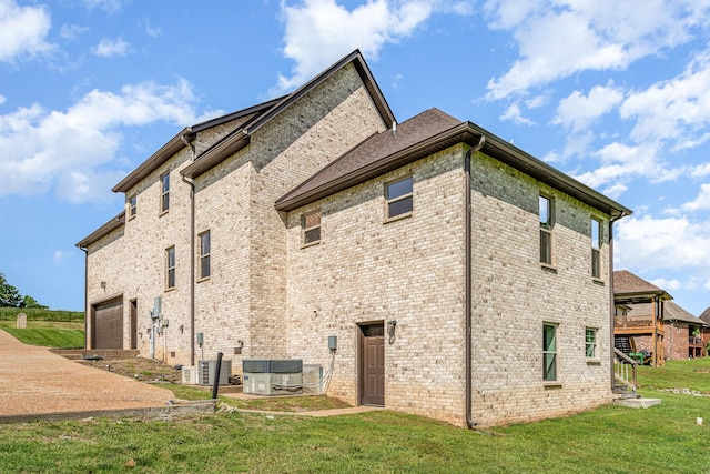 64 Harbor Pt, Lebanon, TN 37087 - rear view of house with a yard, brick siding, a wooden deck, and an attached garage