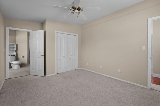 unfurnished bedroom featuring a closet, carpet flooring, a ceiling fan, and baseboards