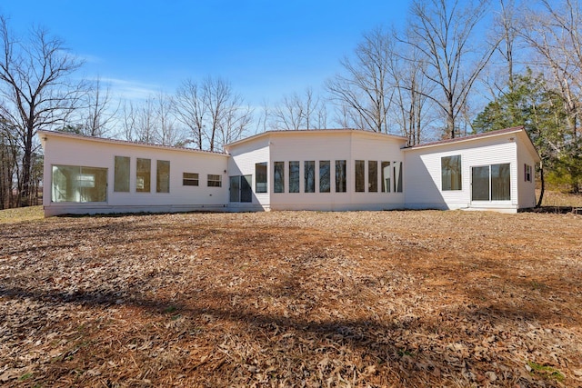 rear view of property with a sunroom