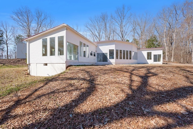 rear view of property with a sunroom and crawl space