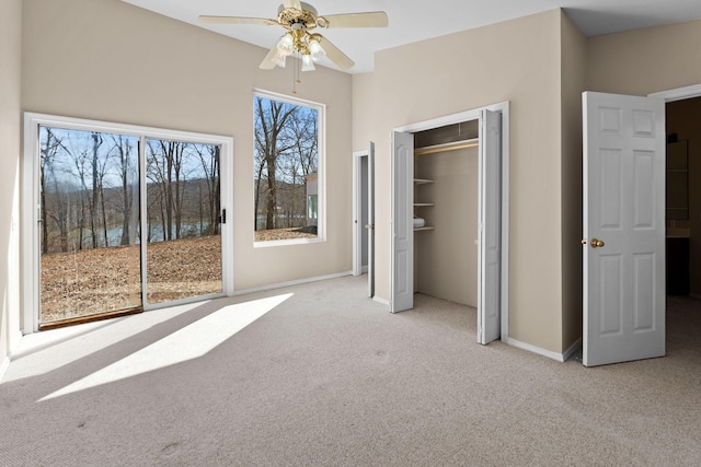 unfurnished bedroom with carpet floors, a ceiling fan, and baseboards