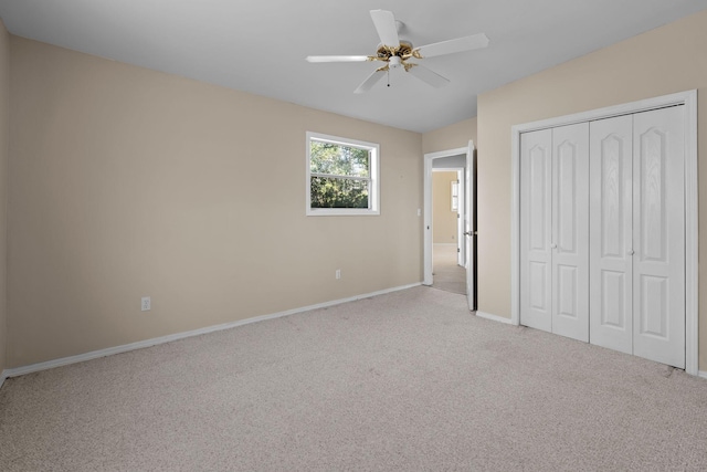 unfurnished bedroom featuring carpet floors, ceiling fan, baseboards, and a closet