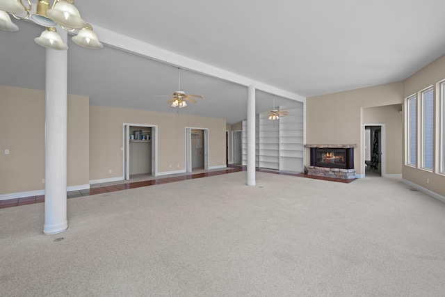 unfurnished living room with carpet floors, built in features, a fireplace, lofted ceiling with beams, and ceiling fan with notable chandelier