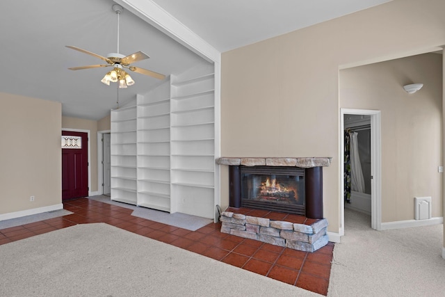 carpeted living room with baseboards, a ceiling fan, lofted ceiling with beams, tile patterned floors, and a fireplace