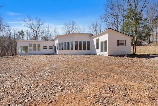 back of house featuring a sunroom