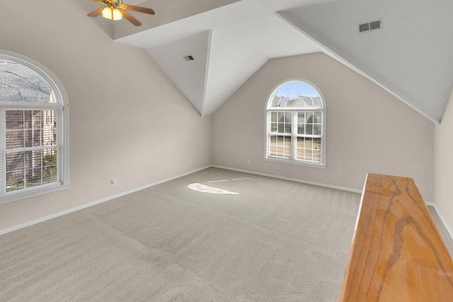 bonus room featuring lofted ceiling, visible vents, and carpet flooring