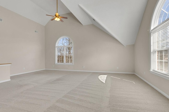 unfurnished living room with visible vents, baseboards, ceiling fan, carpet flooring, and high vaulted ceiling