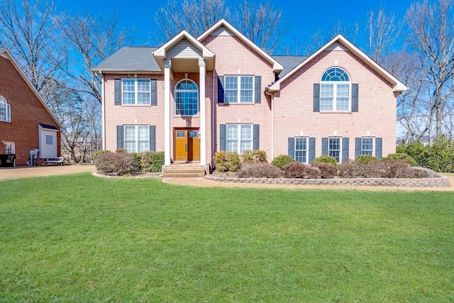 view of front of property with brick siding and a front yard