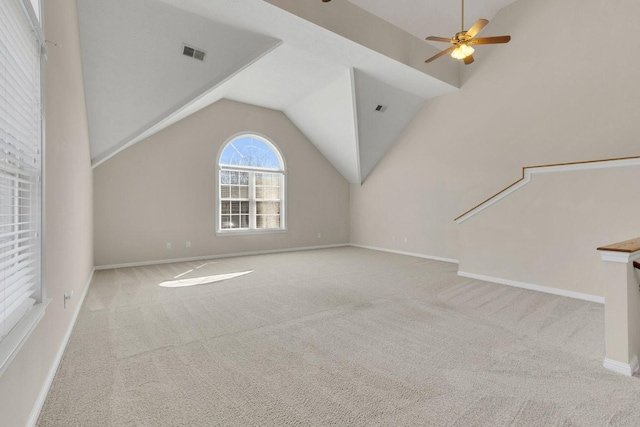 interior space with lofted ceiling, carpet floors, and visible vents