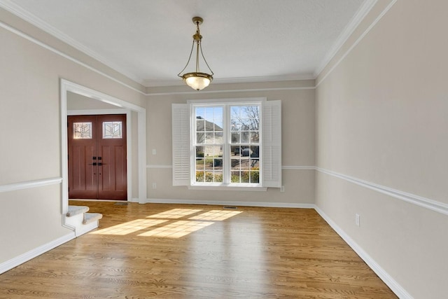 foyer entrance with baseboards, stairway, wood finished floors, and crown molding