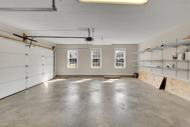 garage with a garage door opener and baseboards