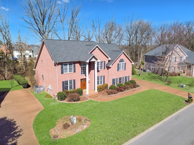 view of front of property with brick siding and a front yard