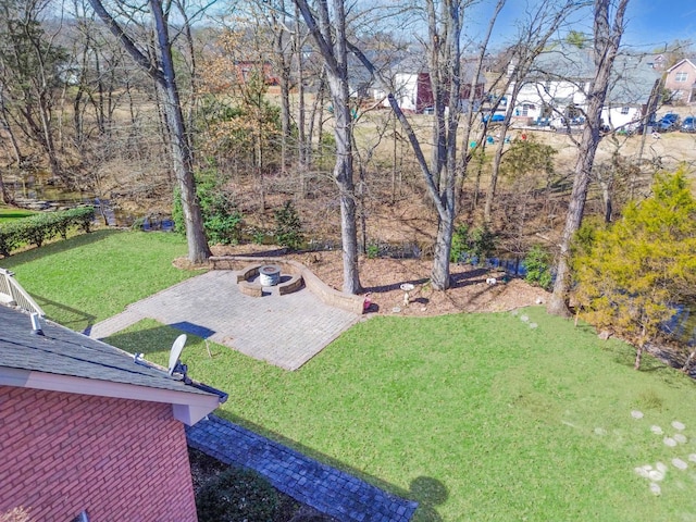 view of yard featuring an outdoor fire pit and a patio