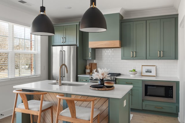 kitchen featuring stainless steel appliances, decorative backsplash, green cabinets, and light countertops