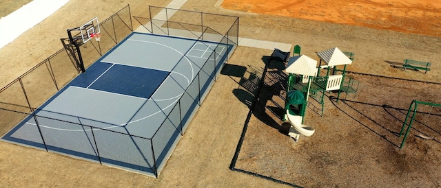 view of basketball court with community basketball court and fence