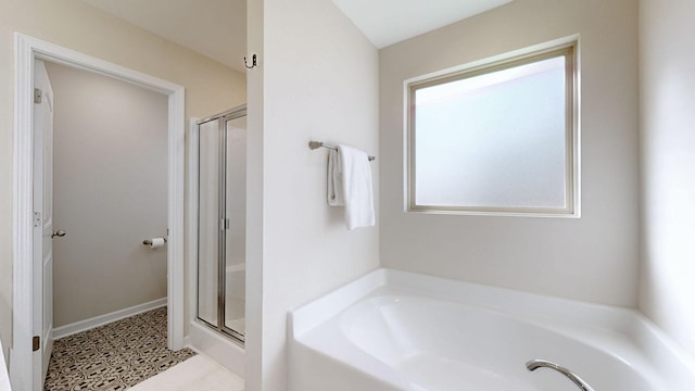 full bathroom with a stall shower and a garden tub