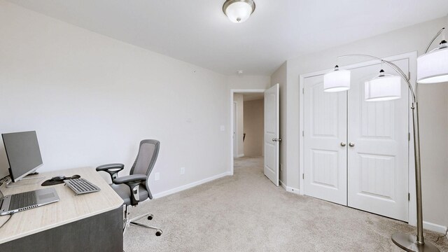 home office featuring light colored carpet and baseboards