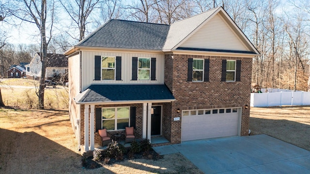 traditional home with a garage, covered porch, brick siding, and board and batten siding