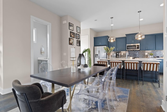 dining room with dark wood-style floors and baseboards