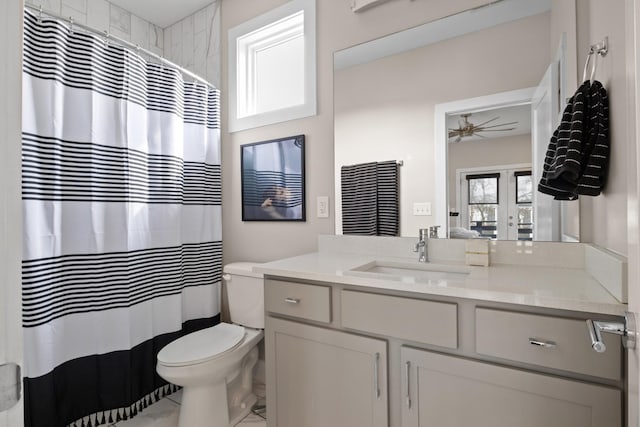 bathroom featuring ceiling fan, toilet, vanity, french doors, and a shower with curtain