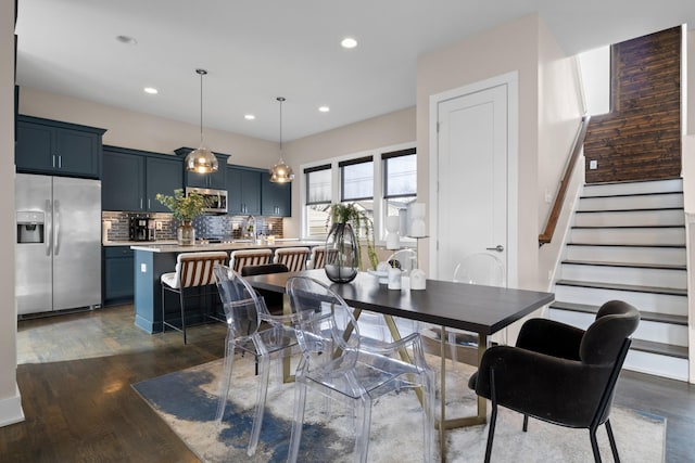 dining area with dark wood-style floors, stairs, and recessed lighting