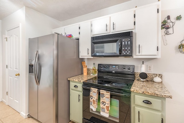 kitchen with light tile patterned floors, white cabinets, black appliances, and light countertops