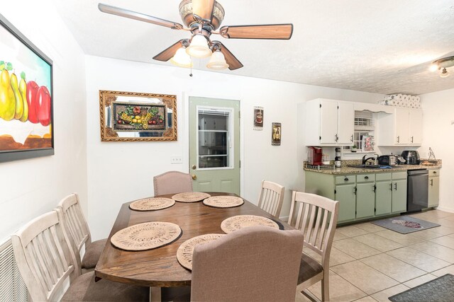 dining room with ceiling fan, a textured ceiling, and light tile patterned flooring