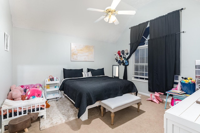 bedroom with lofted ceiling, a ceiling fan, and carpet flooring