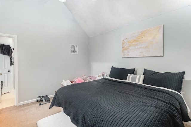 carpeted bedroom with baseboards and vaulted ceiling