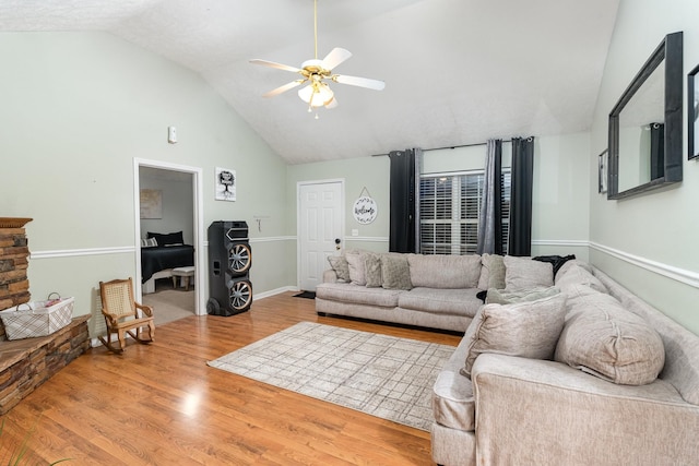 living room featuring ceiling fan, lofted ceiling, and wood finished floors