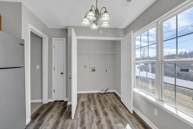 washroom with hookup for a washing machine, laundry area, hookup for an electric dryer, and baseboards