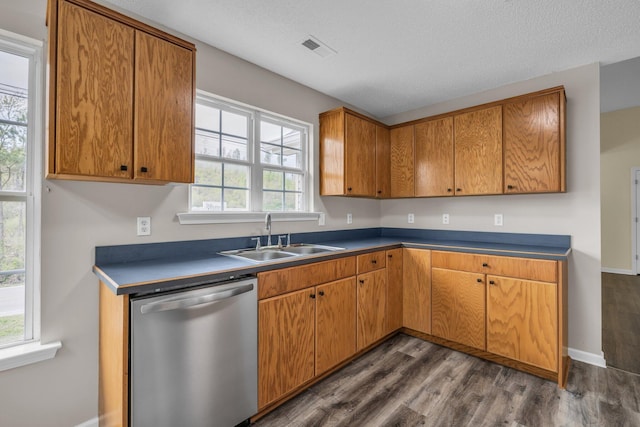 8115 Standifer Gap Rd, Chattanooga, TN 37421 - kitchen with stainless steel dishwasher, brown cabinetry, visible vents, dark wood-type flooring, and a sink