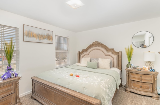 bedroom with light carpet and baseboards