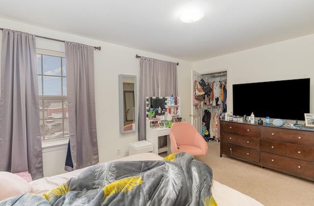 bedroom featuring carpet floors, a walk in closet, and a closet