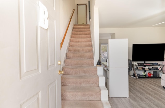 stairs with wood finished floors