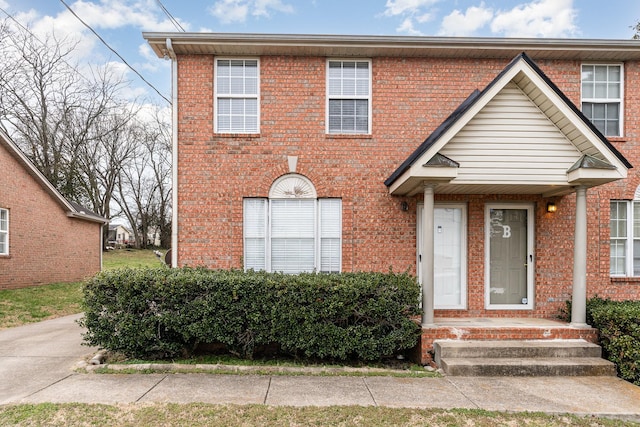 view of property featuring brick siding