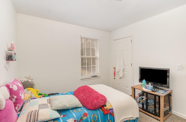 bedroom featuring carpet flooring and baseboards