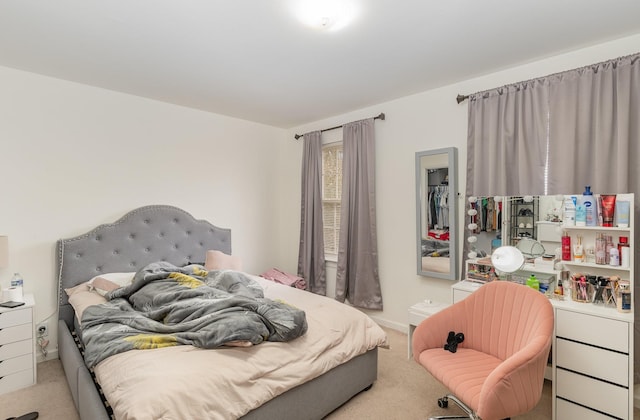 carpeted bedroom featuring baseboards